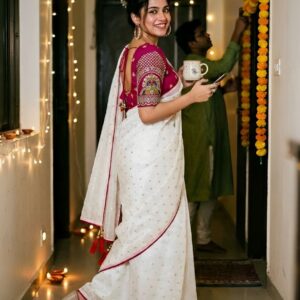 Woman wearing a white saree with border